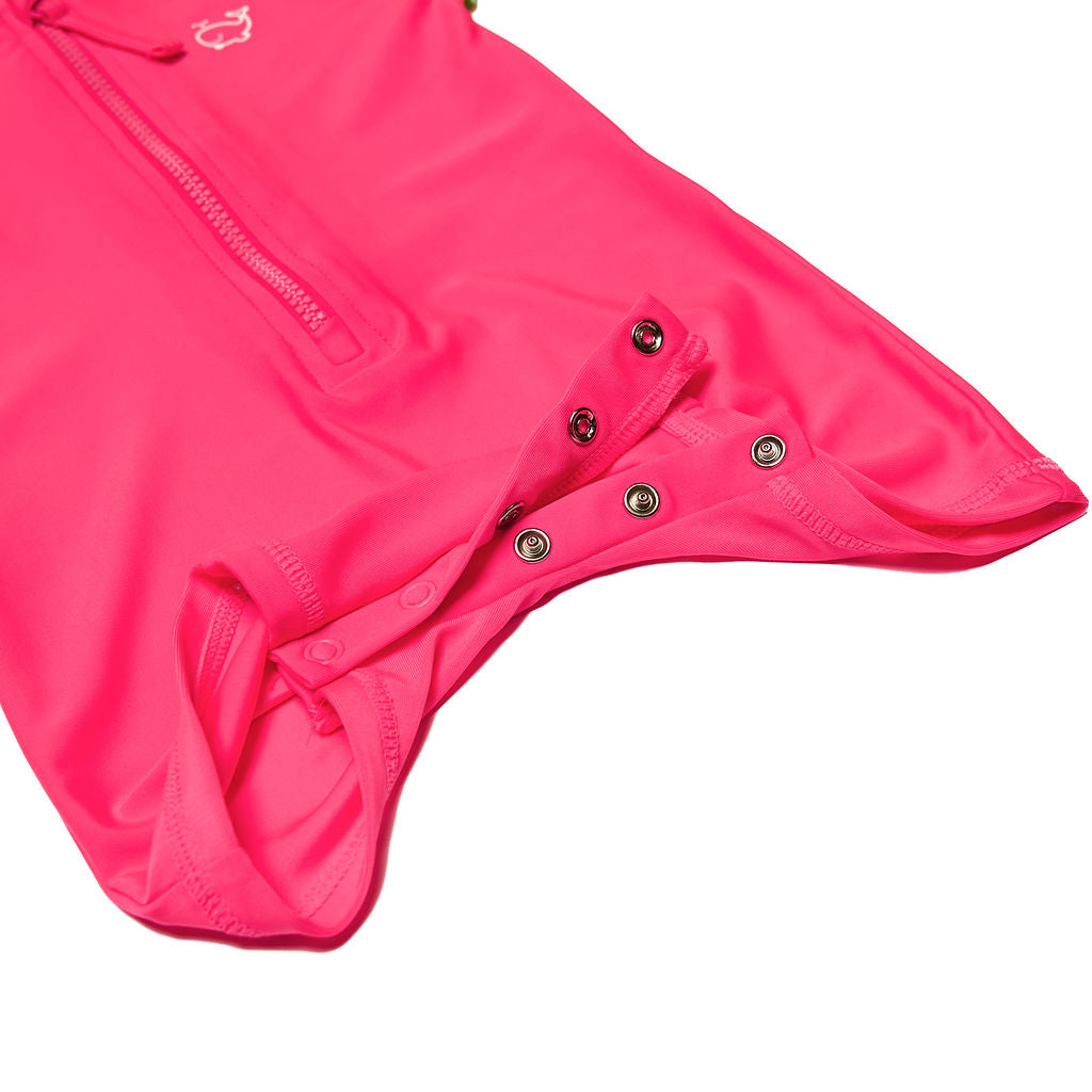 Close up of snaps on infant/toddler neon pink and neon green rash guard one piece.